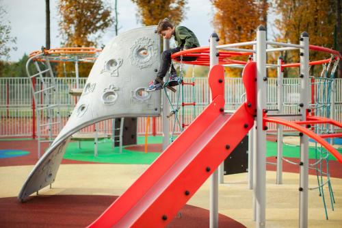 a man on a slide at a playground at Primavera Jastrzębia Góra in Jastrzębia Góra