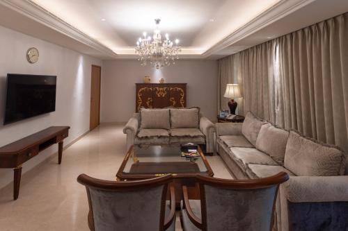 a living room with a couch and a table at Novotel Hyderabad Airport in Hyderabad