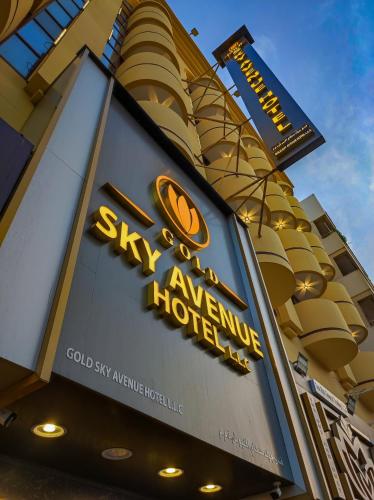 a sign on the side of a hotel at GOLD SKY AVENUE HOTEL in Dubai