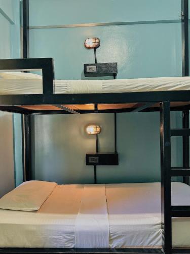 two bunk beds with lights on top of them at Dayon Hostel in Coron