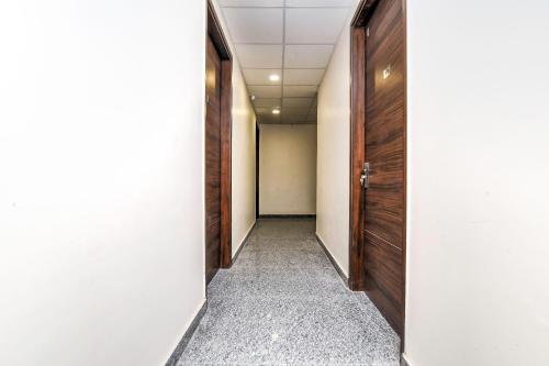 an empty corridor with a door at Flagship RK Residency in Sohāna
