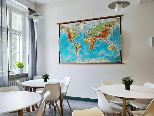 a map of the world hanging on a wall in a restaurant at Hostel Bjorkenheim in Seinäjoki