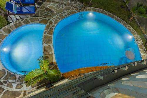 an overhead view of two large blue swimming pools at Waiti homes in Diani Beach