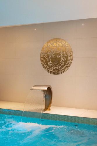 a swimming pool with a water slide in a building at Montcalm Royal London House, London City in London