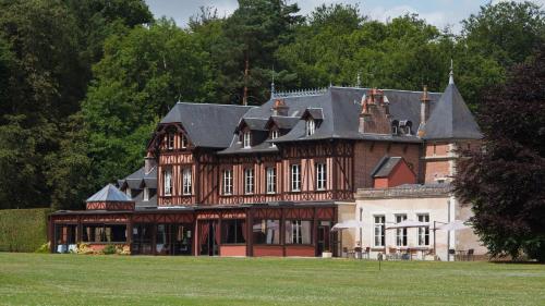 a large brick house with a black roof at Le Pavillon De Gouffern in Silly-en-Gouffern
