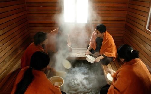 a group of people in a sauna cooking food at Eldorado Resort in Sinan
