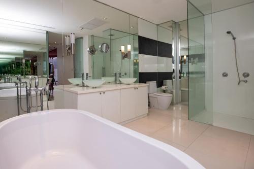 a large bathroom with two sinks and a shower at Private 3-Storey Pool Villa Atika 10, for 7, views of Patong Bay in Patong Beach