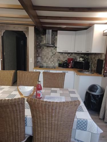 a kitchen with a table and chairs in a kitchen at vogelzang in Oignies-en-Thierache