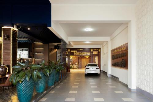a car is parked in the entrance to a store at Mekong Gia Lai Hotel - Me Kong Pleiku in Pleiku