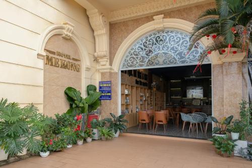 an entrance to a building with plants and a restaurant at Mekong Gia Lai Hotel - Me Kong Pleiku in Pleiku