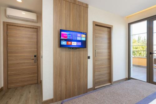 a room with a flat screen tv on a wall at Ema Houses in Antalya