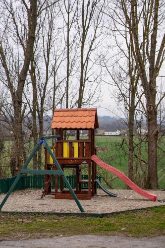 a playground with a slide and a play structure at Apartmaji Babi in Markovci