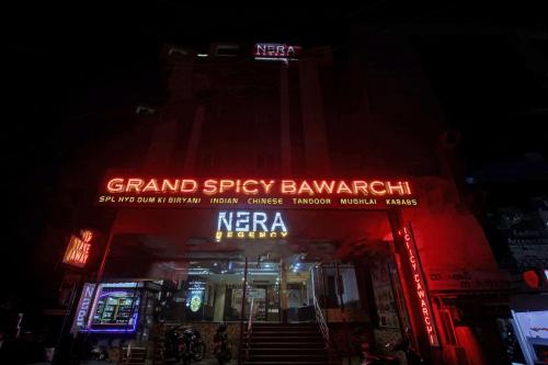 a sign for a grand spicy bangkok store at night at Townhouse Hotel Nera Regency Near Image Hospital in Kondapur