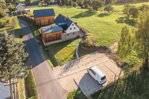 a white truck parked in front of a house at Roubenka U Babi in Lipná