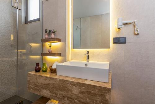 a bathroom with a white sink and a mirror at Ema Houses in Antalya