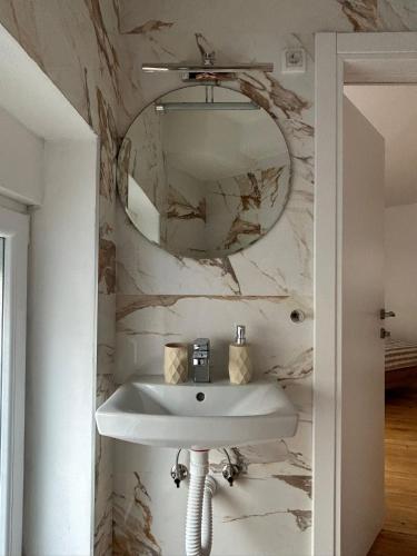 a bathroom with a white sink and a mirror at Kosancic No.1 in Belgrade