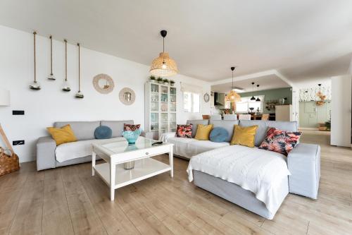 a living room with two couches and a table at Villa Sueños in Mijas