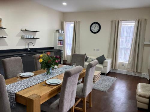 a dining room with a wooden table and chairs at Selwyn Stays in Liverpool