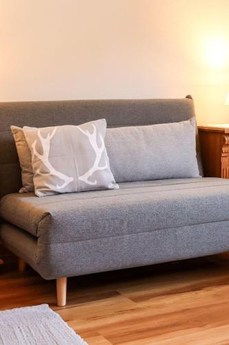 a couch with two pillows on it in a living room at Apartment Vordermitterast in Kirchberg in Tirol