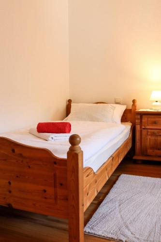 a bed with a wooden frame in a bedroom at Apartment Vordermitterast in Kirchberg in Tirol