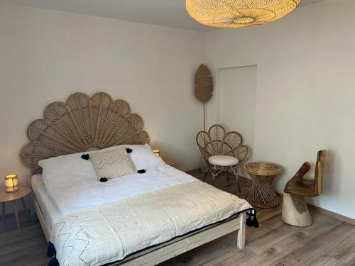 a bedroom with a bed with a large wooden headboard at Apartament BOHO in Częstochowa