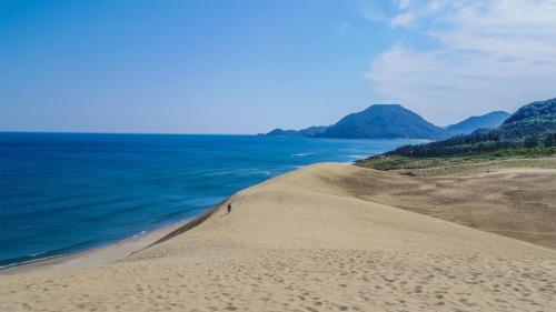 a sand dune next to the ocean on a beach at Toyoko Inn Tottori-eki Minami-guchi in Tottori