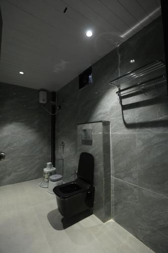 a bathroom with a toilet and a shower at Shreephal luxurious Resort- Best resort in saputara in Saputara