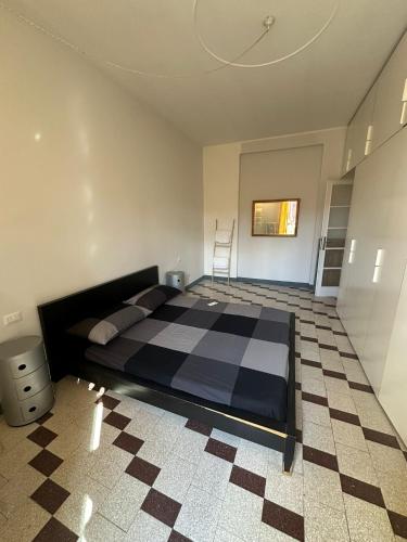 a bedroom with a bed and a checkered floor at Maison San Lorenzo Roma in Rome