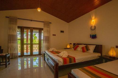 a bedroom with two beds in a room at Jim Dandy House in Tissamaharama