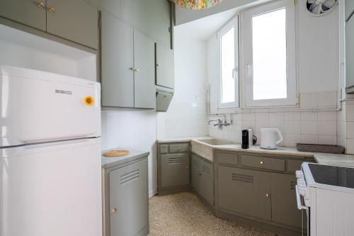 a kitchen with a refrigerator and a sink at Feels like home apartment next to Acropolis in Athens