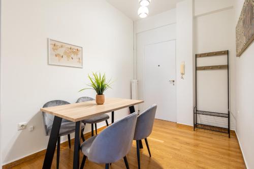 a dining room with a wooden table and chairs at Feels like home apartment next to Acropolis in Athens