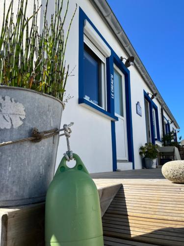 a green fire hydrant next to a house at L'Atelier de Mézareun in Ouessant