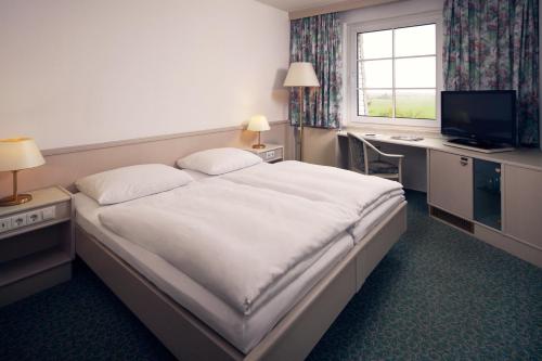 Postel nebo postele na pokoji v ubytování Van der Valk Landhotel Spornitz