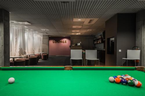 a billiard table in a room with a bar at Johan Suites & Spa in Kuressaare