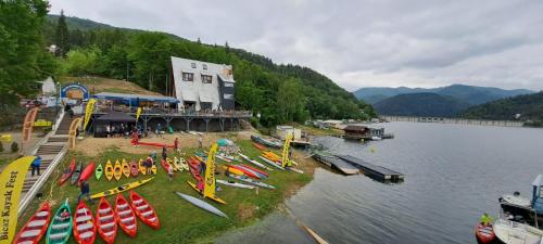 a group of kayaks on the shore of a lake at Hotel Pescarus Port Bicaz in Bicaz