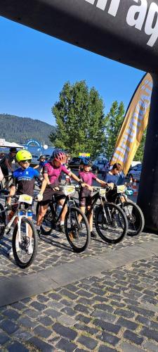a group of people riding bikes on a road at Hotel Pescarus Port Bicaz in Bicaz