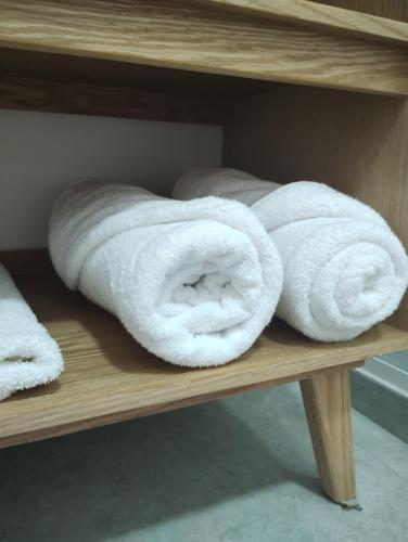 two rolls of towels sitting on a shelf at Onmood Roma Norte by HiHab New Opening 2024 in Mexico City