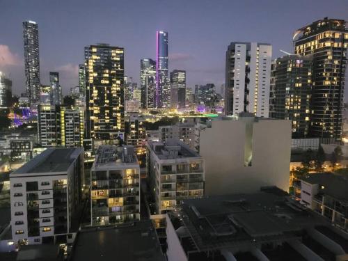 a city skyline at night with tall buildings at Spectacular views, king bd plus single bed & parking in Brisbane