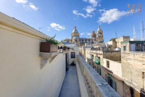 a view from a balcony of a street with buildings at Stunning 3BR Townhouse with Private Rooftop Access by 360 Estates in Paola