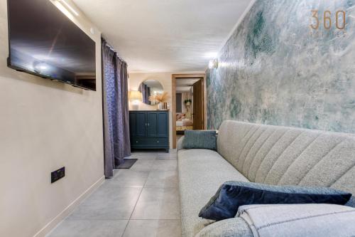a living room with a couch and a tv at Stunning 3BR Townhouse with Private Rooftop Access by 360 Estates in Paola