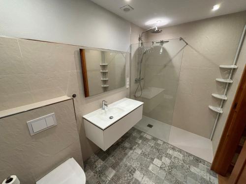 a bathroom with a sink and a shower and a toilet at L´Escala in Denia