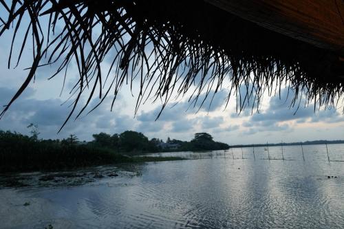 a view of a river from a straw hut at Lake Resort Bolgoda in Wadduwa