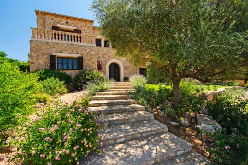 a stone pathway leading to a house with a tree at VILLA ALENAR - Marratxi- Mallorca in La Cabaneta