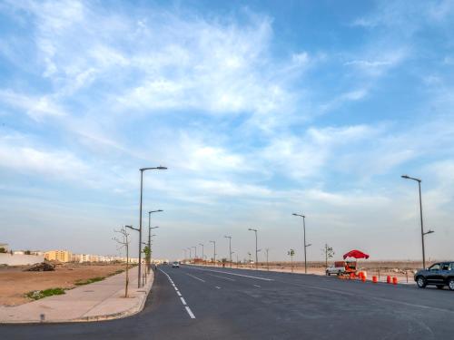 an empty road with street lights on the side of the road at Aliya Luxury Apartment - LA DUNE - AGADIR in Agadir