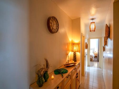 a kitchen with a counter and a clock on the wall at Aliya Luxury Apartment - LA DUNE - AGADIR in Agadir