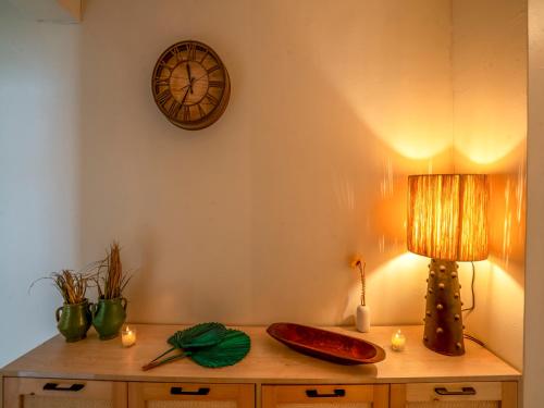 a room with a table with a clock on the wall at Aliya Luxury Apartment - LA DUNE - AGADIR in Agadir