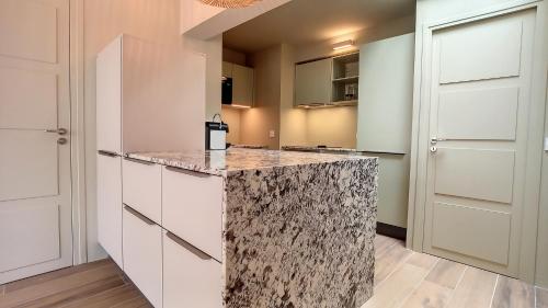 a kitchen with a granite counter top at Villa ALFONSA in Saint-Raphaël