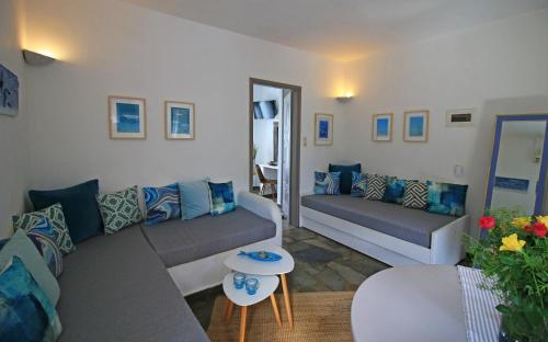 a living room with two couches and a table at Captain's in Kinion