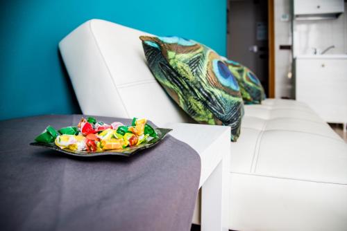 a plate of candy on a table next to a white chair at Bed & Breakfast Tiffany in Domodossola