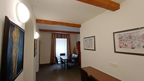 a hallway with a room with a table and a window at Apartments Gato Karlovy Vary Dalovice in Karlovy Vary